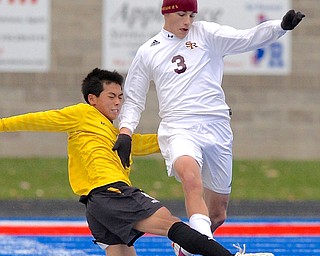 Jeff Lange | The Vindicator South Range's Cole Frank (3) dribbles the ball as Beachwood's Junyoung Lee slides to steal the ball away from him in the second half of Saturday's Regional Final game in Ravenna.