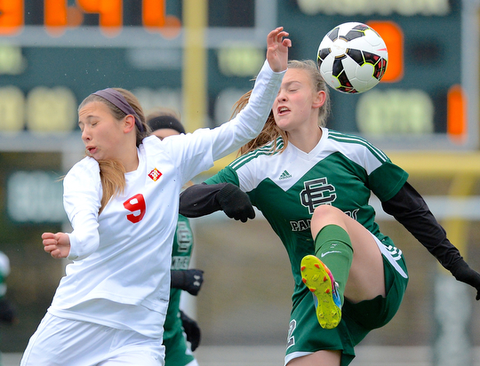Jeff Lange | The Vindicator  Mooney's Lexy Herman (left) collides with Elyria's Ryan Kunkle as she kicks the ball over her head in first half action at Nordonia High School, Saturday afternoon.