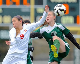 Jeff Lange | The Vindicator  Mooney's Lexy Herman (left) collides with Elyria's Ryan Kunkle as she kicks the ball over her head in first half action at Nordonia High School, Saturday afternoon.