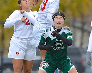Jeff Lange | The Vindicator  Mooney's Kellie Walker (29) heads the ball over the defense of Elyria's Jenna Ellington (19) in the first half of their Regional Finals in Nordonia, Saturday, November 1st. Mooney's Damani Santiago looks on from behind.