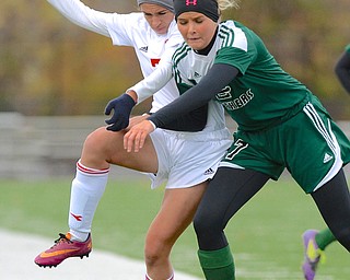 Jeff Lange | The Vindicator  Mooney's Elizabeth Philibin (left) and Elyria's Ally Kamody (right) crash into each other while chasing down the ball in the first half of their Saturday afternoon game for the Regional Title.
