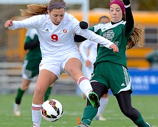 Jeff Lange | The Vindicator  Mooney's Lexy Herman (9) kicks the ball past Elyria's Anna Griffin (right) in the first half of their matchup, Saturday afternoon in Nordonia.