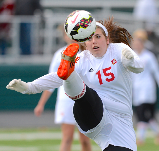 Jeff Lange | The Vindicator  Cardinal Mooney's Emilee Mulhall eyes the ball as she kicks it over her head in the second half of Mooney's matchup with Elyria, Saturday in Nordonia.