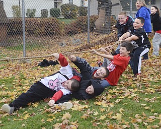 Katie Rickman | The Vindicator.Students at Struthers Middle School join in on a game of tug-of-war during the tailgate party where the PANDA Leadership Club offered face painting, fake tattoos, games, and goggles that simulated the effects of driving drunk.