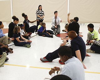        ROBERT K. YOSAY  | THE VINDICATOR..Susan Inmand  of Quaglia and Mrs Margarita Harris of Paul Bunn  get the students to  interact - ..Elementary students from throughout the Youngstown school district gather for the first time to talk about  the Quaqlia program.  Quaglia program is aimed at bolstering academic achievement .....-30-