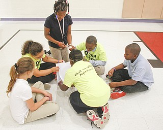        ROBERT K. YOSAY  | THE VINDICATOR..Students from different grades and schools start building the paper towers together sharing ideas etc..Elementary students from throughout the Youngstown school district gather for the first time to talk about  the Quaqlia program.  Quaglia program is aimed at bolstering academic achievement .....-30-