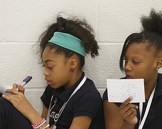       ROBERT K. YOSAY  | THE VINDICATOR..Terry'Onna Reashton 6th grader and Tanistia Bates a fifth grader  work together..as part of a speaking and listening exercise - each student had to draw or right something and help the other student understand it..Elementary students from throughout the Youngstown school district gather for the first time to talk about  the Quaqlia program.  Quaglia program is aimed at bolstering academic achievement .....-30-