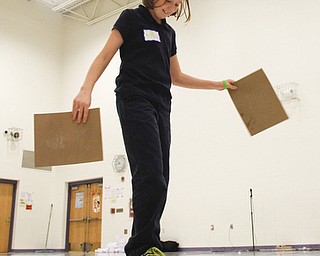        ROBERT K. YOSAY  | THE VINDICATOR..a challenge exercise on how to get your team over the "lava" using rocks ( of Cardboard)  as Stephanie Shelly slides and carrys a set of blocks for a team member ..Elementary students from throughout the Youngstown school district gather for the first time to talk about  the Quaqlia program.  Quaglia program is aimed at bolstering academic achievement .....-30-