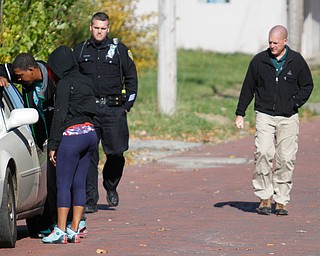        ROBERT K. YOSAY  | THE VINDICATOR..on Covington YPD investigates a  blot of blood as a person was taken away before police arrived..E...-30-