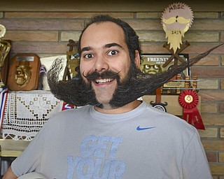 Katie Rickman | The Vindicator.Anthony Fontes poses for a photo in his Campbell home with his "swoosh" styled beard on Thursday, Oct. 30, 2014. .Fonte's has won several trophies and hopes to start a beard club.