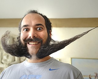 Katie Rickman | The Vindicator.Anthony Fontes poses for a photo in his Campbell home with his "swoosh" styled beard on Thursday, Oct. 30, 2014. .Fonte's has won several trophies and hopes to start a beard club.