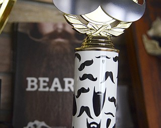 Katie Rickman | The Vindicator.One of the trophies that Anthony Fontes won in a beard contest sits on his mantel in his Campbell on Thursday, Oct. 31, 2014.