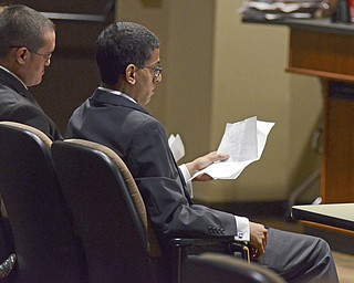 Katie Rickman | The Vindicator.College Democrat President Ernie Barkett reads over notes during the political debate against College Conservatives, Tony Peterson sits to his right on Thursday, Oct. 30, 2014 at Debartolo Lecture Hall.
