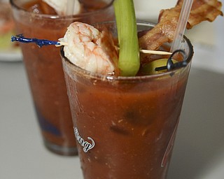 Katie Rickman | The Vindicator.The Progressive is one of the signature drinks at Saadeys Place in Austintown and features absolut, tomato juice, spices, Worcestershire, tabasco garnish with crispy bacon with chilled shrimp and celery. The Drink runs for $10