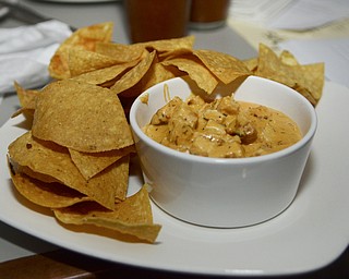 Katie Rickman | The Vindicator.The Buffalo Chicken Dip at Saadey's is one of the signature dishes at Saadeys Place in Austintown and features shredded chicken, spicy cheese sauce served with corn tortilla chips and runs for $7.