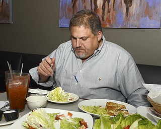 Katie Rickman | The Vindicator.Mike Vallas of Brothers in Food eats at Saadeys Place in Austintown with Mark Smesko during the groups critique on Thursday, Oct. 30, 2014.