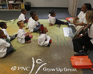  .          ROBERT  K. YOSAY | THE VINDICATOR..Listening intently with their PNC mat and PNC tea shirts -Jill Kyees and Thasha (ok) Jackson read to the students..At the Mill Creek Childrens Center Preschoolers participated in the Guinness World Record attempt at largest vocabular lesson. ItÕs sponsored by PNC Bank...-30-