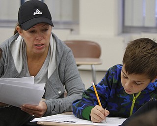  .          ROBERT  K. YOSAY | THE VINDICATOR..Melissa Wern a parent volunteer helps Noah Dearing .Polands McKinleyÕs math club meets. before school and is  thriving math enrichment programs, with the help of volunteers and staff....-30-