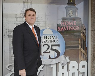 Katie Rickman | The Vindicator.Gary Small, CEO at The Home Savings and Loan Company poses for a photo next to the entryway of the bank on Friday, October 31, 2014. The bank is has been in business for 125 years.