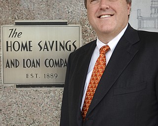 Katie Rickman | The Vindicator.Gary Small, CEO at The Home Savings and Loan Company poses for a photo next to the entryway of the bank on Friday, October 31, 2014. The bank is has been in business for 125 years.