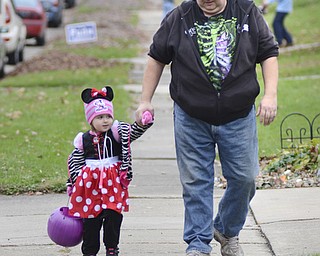 Katie Rickman | The Vindicator.Alan Clark walks with his daughter Courtney, 3 who dressed up as minnie mouse for Hubbard's trick-or-treat on Thursday, Oct. 30, 2014.