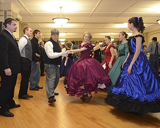 Katie Rickman | The Vindicator.Dan Gibboney of Pulaski, Pennsylvania, on left, "reels" with Becca Howdyshell of Cuyahoga Falls during the Virginia Reel at The Governor David Tod Civil War Ball at the Tyler History Center in Youngstown on Saturday, Nov. 1, 2014.