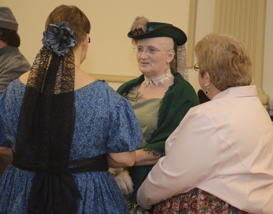 Katie Rickman | The Vindicator.Cindy Lintz, center, of Columbiana talks with Kari Novak, left of Columbiana and Lisa Marie Eckenrode of Warren prior to the Grand March at The Governor David Tod Civil War Ball at the Tyler History Center in Youngstown on Saturday, Nov. 1, 2014.