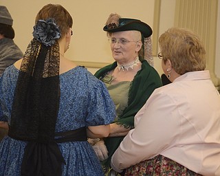 Katie Rickman | The Vindicator.Cindy Lintz, center, of Columbiana talks with Kari Novak, left of Columbiana and Lisa Marie Eckenrode of Warren prior to the Grand March at The Governor David Tod Civil War Ball at the Tyler History Center in Youngstown on Saturday, Nov. 1, 2014.