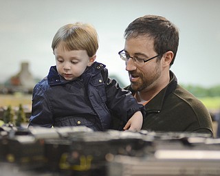 Katie Rickman | The Vindicator.Eric Pellegrini of Austintown holds his two-year-old son James up to look at the Youngstown Model Railroad Association in Austintown on Sunday Nov.2, 2014. Approx. 2,500 visited the facility over its 6 day event according to Dean Demain, Vice President of the society.  The association will have two more open house events November 8-9 and December 6-7 from 12pm-6pm each day.  The cost of admission is $4 for adults, children 11 and under are free.