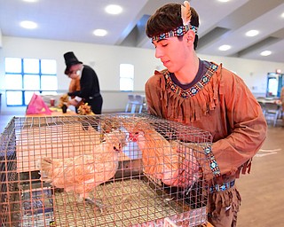 CANFIELD, OHIO - NOVEMBER 1, 2014: Joe Fagano a 4H member puts a show chicken in its cage Saturday morning during the Farm Harvest Fun Fest. (Photo by David Dermer/Youngstown Vindicator)