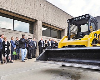 Jeff Lange | The Vindicator A crowd of press and Laird workers watch as a skid steer drives down the loading ramp as it's controlled wirelessly by a LRC-M Radio Control System, Thursday afternoon outside of Laird's facility in Warren.