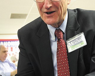 Ralph Meacham is all smiles as he gets election results Tuesday night at Mahoning County Republican headquarters. The political newcomer defeated incumbent Mahoning County Auditor Michael Sciortino.