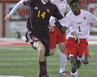 William D. Lewis the Vindeicator  SR Lucas Beabout(14) and Mansfield'sChandran Higgins(1) go for the ball during playoff action in Wadsworth.