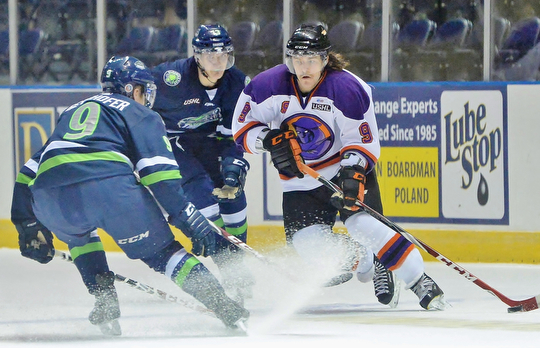 Jeff Lange | The Vindicator  Phantoms' Taylor Best (9) weaves in between Bloomington players Tyler Gernhofer (front left) and Jake Slaker (back) during first period action at the Covelli Centre, Wednesday morning.