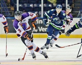 Jeff Lange | The Vindicator  Youngstown's Bryan Lemos (13) takes the puck down the ice as he is pursued by a gaggle of Bloomington and Youngstown skaters during second period action at the Covelli Centre, Wednesday morning.