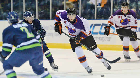 Jeff Lange | The Vindicator  Youngstown's Max Letunov (7) skates across the ice into the defense of Butrus Ghafari (2) as teammate Kris Myllari (27) trails the play from behind during third period action in Youngstown, Wednesday morning.