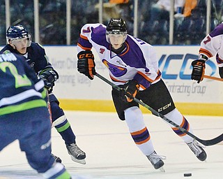 Jeff Lange | The Vindicator  Youngstown's Max Letunov (7) skates across the ice into the defense of Butrus Ghafari (2) as teammate Kris Myllari (27) trails the play from behind during third period action in Youngstown, Wednesday morning.