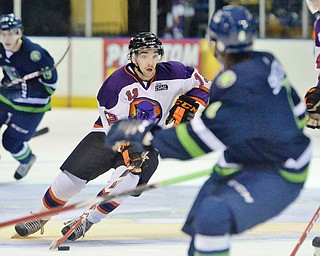 Jeff Lange | The Vindicator  Phantoms' Bryan Lemos (13) handles the puck across the ice through Bloomington players during third period action in Youngstown, Wednesday afternoon.
