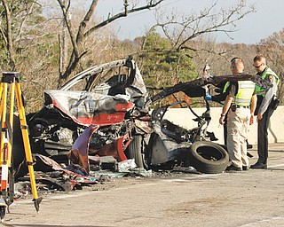 Officials look at the damage to the vehicle of Karen Zorn, 27, of Maryland, who died as a result of the crash on the Ohio Turnpike on Wednesday morning. In all, six vehicles were involved and five people suffered injuries in the westbound lanes of the turnpike near Kirk Road in Austintown Township.