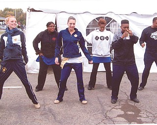 Spencer Sulick, the Thiel College feature twirler, is with her friends from band at a homecoming tailgating party doing the Wobble dance. In front from left are Morgan Steiner of Derry, Pa., Spencer Sulick of Sharon, Pa., and Asia Branch of Annapolis, Md. In back are Shayla Cummings, Leslie Myrick and Loyal Jasper, all of Pittsburgh.