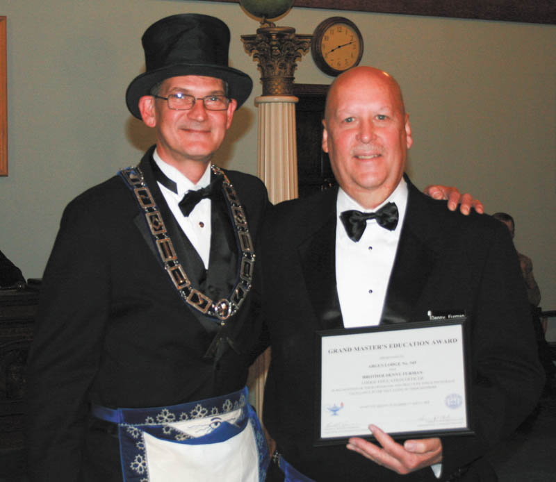 SPECIAL TO THE VINDICATOR Ohio Masonic Grand Lodge of Ohio, which gathered for its annual meeting Oct. 17 in Cincinnati, presented Denny Furman, at right, lodge education officer of Argus Lodge 545 F&AM in Canfield, with the Grand Masters Education Award. The award is given in recognition of the programs and practices that encourage excellence in the education of the lodge members. At left is Mark Roca.