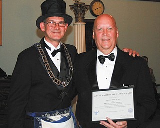 SPECIAL TO THE VINDICATOR Ohio Masonic Grand Lodge of Ohio, which gathered for its annual meeting Oct. 17 in Cincinnati, presented Denny Furman, at right, lodge education officer of Argus Lodge 545 F&AM in Canfield, with the Grand Masters Education Award. The award is given in recognition of the programs and practices that encourage excellence in the education of the lodge members. At left is Mark Roca.