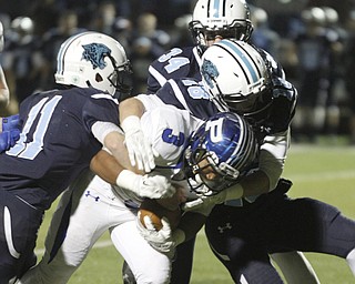  .          ROBERT  K. YOSAY | THE VINDICATOR..Takes two Louisville defenders #11 Joe Crank  and Jake Mathie as #34  Kyle Ashcraft looks on.. after #3 Marlon Raimirez carries them for a few extra yards during second quarter action..Poland Bulldogs vs Louisville Leopard at Louisville....-30-