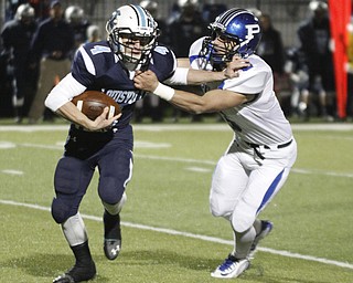ROBERT  K. YOSAY | THE VINDICATOR..Polands #6  Geno Petrus catches Louisville #4  Walter Schrock  as he is met at the line of scrimmage.Poland Bulldogs vs Louisville Leopard at Louisville