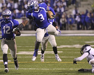 William D. Lewis the vindicator  Hubbards Larry Scott(3) jumps over Tallmadges Joseph Vassalotti(4) during11-7-14 game against Tallmadge.At left is Hubbard's Brett Lopuchovsky(12).