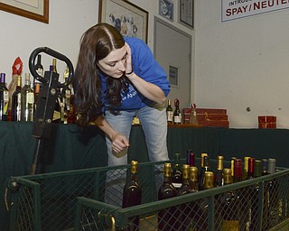 Katie Rickman | The Vindicator.Lauren Potts of Austintown, the Outreach Director for Angels for Animals organizes wine for the Wine Pull at the Wine Tasting fundraiser at Angels For Animals on Saturday, Nov. 8, 2014.