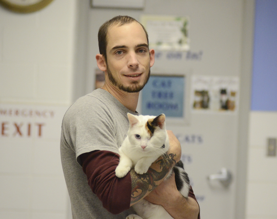 Katie Rickman | The Vindicator.Keith Novotak, Feline Manager at Angels For Animals holds Suzie, a female cat that is up for adoption on Saturday, Nov 8, 2014.  At the Empty the Shelters event that took place, Angels for Animals adopted out 20 cats during the day-long event.