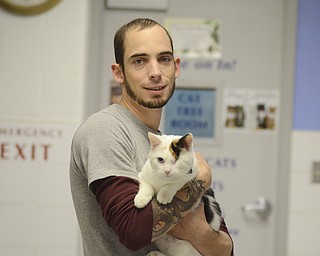 Katie Rickman | The Vindicator.Keith Novotak, Feline Manager at Angels For Animals holds Suzie, a female cat that is up for adoption on Saturday, Nov 8, 2014.  At the Empty the Shelters event that took place, Angels for Animals adopted out 20 cats during the day-long event.
