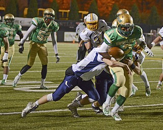 Katie Rickman | The Vindicator.Ursuline's Anise Algahmee  runs up field during the first quarter as United's Tyler Powers tackles him during the game at Stambaugh on Saturday, Nov. 8, 2014.