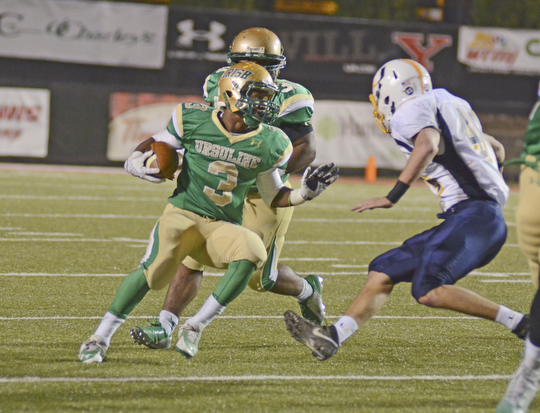 Katie Rickman | The Vindicator.United's Kimauni Johnson runs up field during the first quarter as United's Eric Blosser attempts to block him during thegame at Stambaugh on Saturday, Nov. 8, 2014.